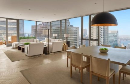 Times Square EDITION hotel suite. Luxury gay-friendly hotel in Hell's Kitchen. Living room and dining area with city views.
