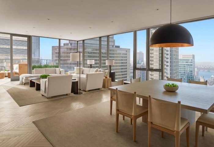 Times Square EDITION hotel suite. Luxury gay-friendly hotel in Hell's Kitchen. Living room and dining area with city views.