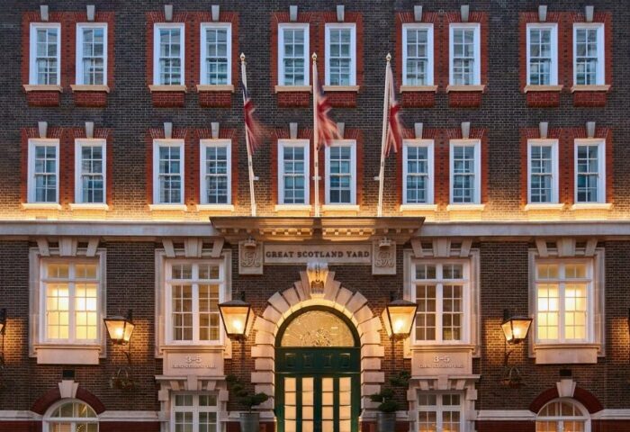 Great Scotland Yard Hotel facade, a luxury gay hotel in London. Union Jack flags fly above the entrance. Best hotel near Soho.