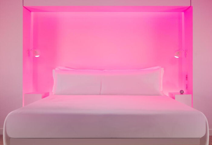 St Martins Lane Hotel London room with pink lighting. A best luxury gay hotels option for gay couples in London. Modern, stylish decor.