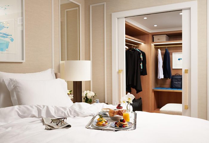 Corinthia Hotel Lisbon honeymoon suite. Breakfast in bed, closet with clothes. Gay couples luxury travel hotel ideas.