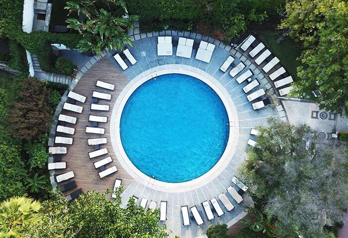Aerial view of Tivoli Avenida Liberdade's luxury pool in Lisbon's gayborhood. Best honeymoon hotel idea with sun loungers.