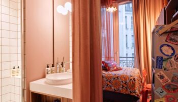 25hours Hotel Terminus Nord room. Paris hotel near gay bars, featuring eclectic decor, bathroom, and a view. Best Paris view hotel.