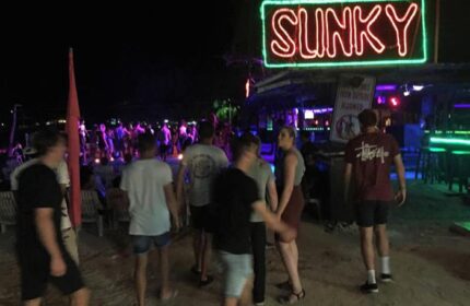 ChaoKoh Phi Phi Hotel Resort's beach party at Ton Sai. Slinky neon sign above the bar. Best party beach, gay hotel.