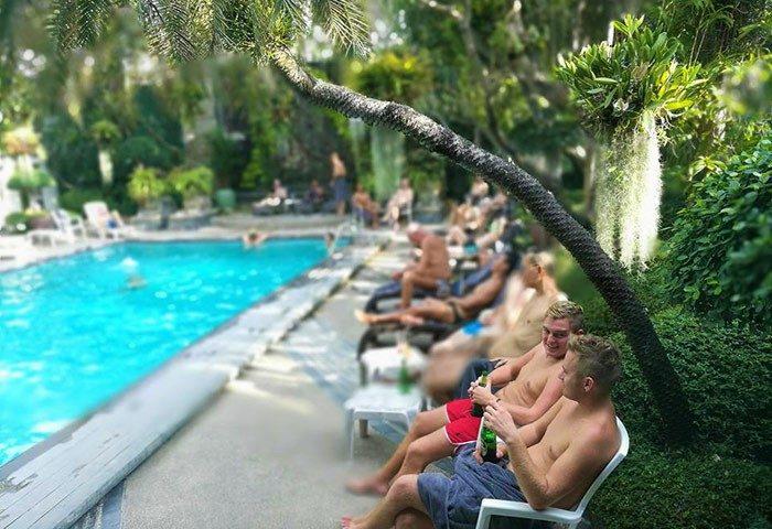 Babylon Bangkok Hotel: Gay men relax by the pool, a popular spot to meet other gay men. Best place to socialize in Bangkok, Thailand.