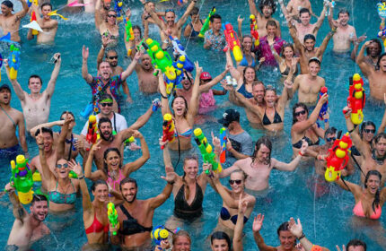 Ibiza House pool party. Gay hostel in Koh Phi Phi features partygoers with water guns in a pool. Best pool party for gay men travel.