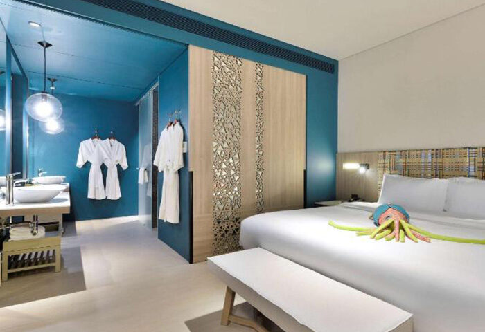 Veranda Resort Pattaya MGallery: Gay honeymoon hotel room. Blue walls, bathrobes, bed with octopus towel art. Best private beach resort.