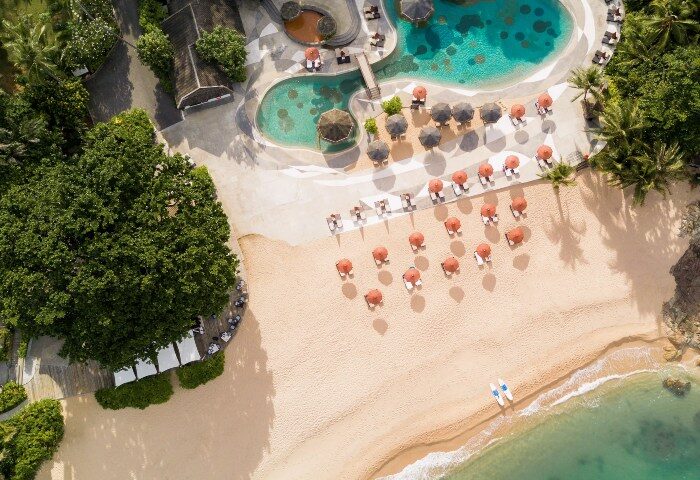 Garrya Tongsai Bay Samui aerial view. Beachfront private pool villa, gay-friendly hotel in Koh Samui. Umbrellas, beach chairs, turquoise pools.