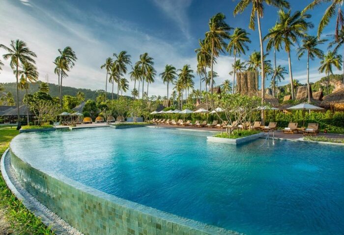 SAii Phi Phi Island Village's private pool villa. Best gay honeymoon destination. Palm trees, beach, and clear blue water create a relaxing vibe.
