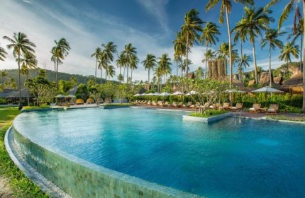 SAii Phi Phi Island Village's private pool villa. Best gay honeymoon destination. Palm trees, beach, and clear blue water create a relaxing vibe.