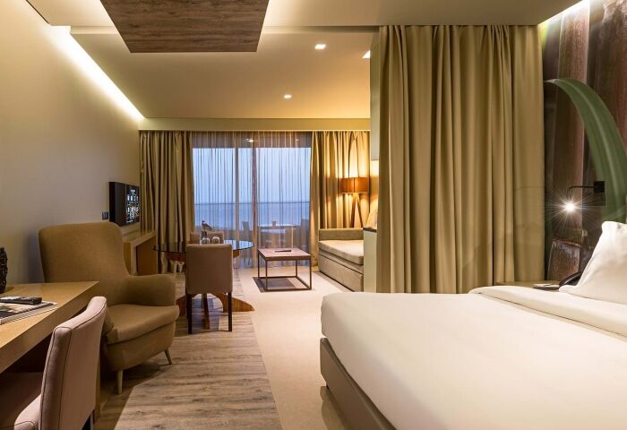 Saccharum Madeira Portugal: Hotel room interior at a quiet beach holiday destination near London. Modern design, neutral tones, and a view.