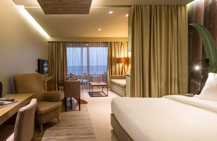 Saccharum Madeira Portugal: Hotel room interior at a quiet beach holiday destination near London. Modern design, neutral tones, and a view.