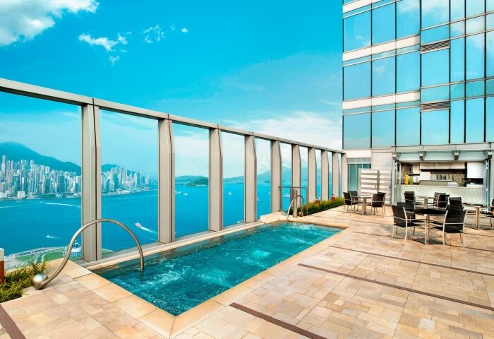 Rooftop pool at W Hong Kong, a gay-friendly luxury hotel. The pool overlooks Victoria Harbour, offering stunning city views. Perfect for gay travelers.