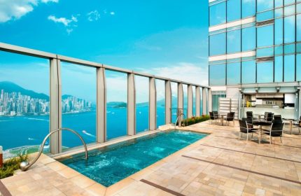 Rooftop pool at W Hong Kong, a gay-friendly luxury hotel. The pool overlooks Victoria Harbour, offering stunning city views. Perfect for gay travelers.