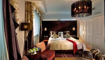 The Grand Mark Prague hotel room. Gay hotels in Prague city center offer best room offers. Luxury interior with double bed.
