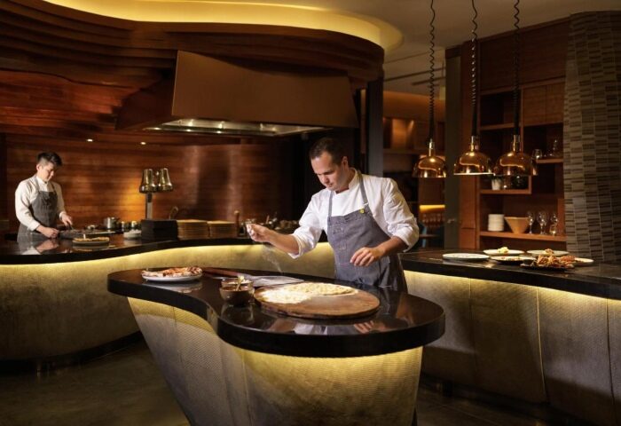 Chef preparing brunch at voco Orchard Singapore, an IHG Hotel. Best Sunday brunch offers at this gay-friendly Singapore hotel.