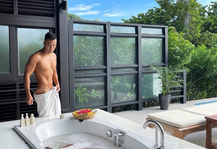 Garrya Tongsai Bay Samui gay hotel: Fit man with towel by tub. Best wellness beachfront hotel in Koh Samui for gay men's travel advice.