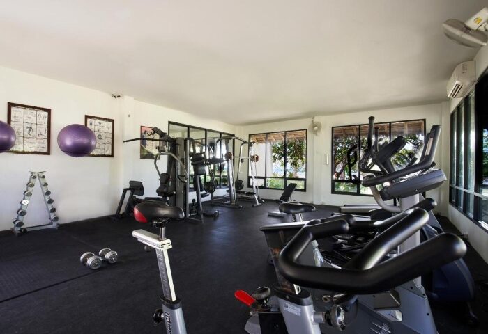 SAii Phi Phi Island Village's gym. Wellness and fitness equipment for gay travelers. Private beach resort with exercise bikes, weights, and machines.