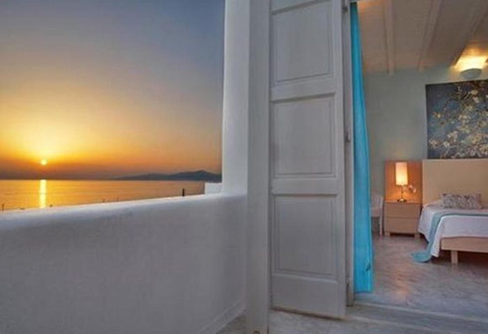 Sunset view from Porto Mykonos Hotel, a popular gay honeymoon destination in Mykonos Town. Room with balcony overlooking the sea.