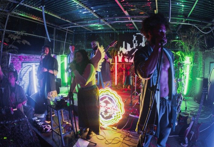 Live music at BirdCage Club, Hanoi. Band performing on stage with neon lights. Gay travel in Vietnam. Nightlife, entertainment.