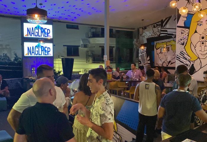 Gay party at Blondies Loft Slushbar in Puerto Vallarta. Men socializing at a popular gay bar with pop art decor and a lively atmosphere.