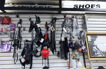 Inside a New York gay shop: fetish gear on display. Leather harnesses, lingerie, and other adult items for sale. Travel advice for gay men.