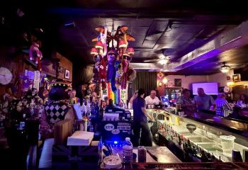 Bobby's Monkey Bar in Key West. A popular gay bar known for its strong drinks, karaoke, and quirky decor, including monkey dolls.