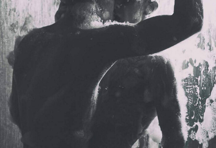 Two men in a shower at BodyBreath Cruise Club Tokyo, a gay cruise club. The photo is in black and white, with soap covering their bodies.