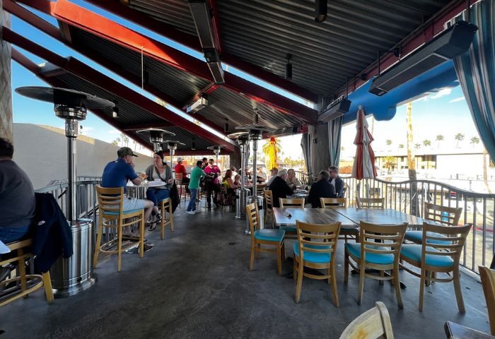 Bongo Johnny's Patio Bar & Grill dine area. Outdoor seating at gay-friendly Palm Springs restaurant. Patio heaters, tables, and chairs.