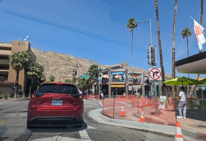Bongo Johnny's Patio Bar & Grill location in Palm Springs. Gay travel destination with outdoor seating, palm trees, and mountain views.