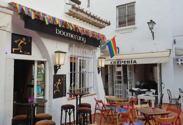 Boomerang Gay Bar in Torremolinos, Spain. Exterior view with rainbow flag and decorations. Gay travel destination for men.
