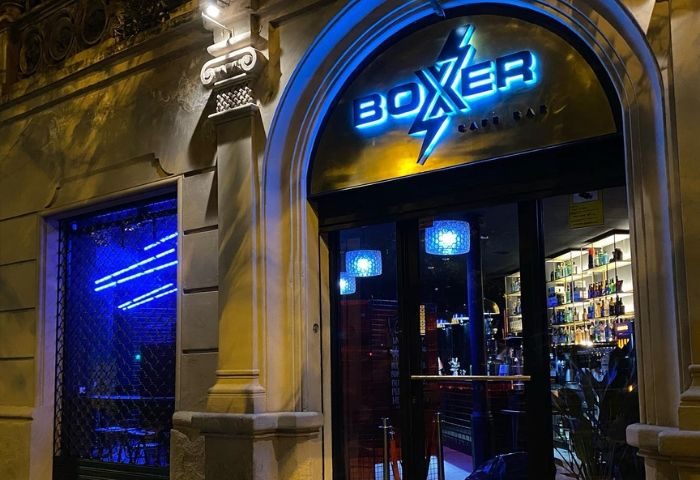 Boxer Cafe Bar gay bar in Barcelona. Blue neon sign above the entrance. Gay travel advice, nightlife.