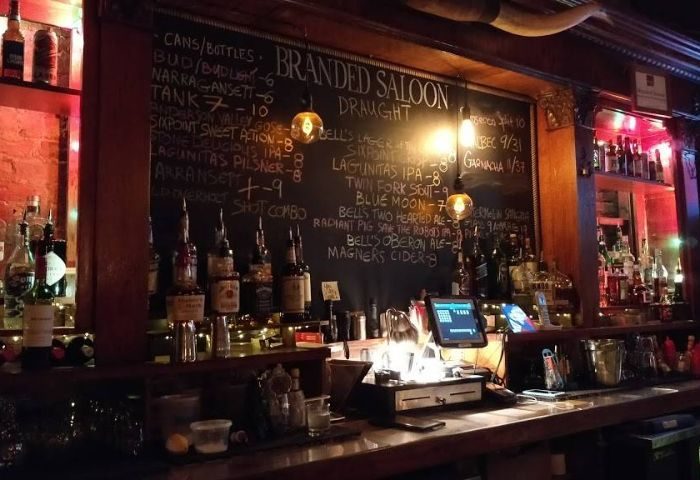Branded Saloon, New York. Gay bar with chalkboard menu listing beers, including Lagunitas IPA. A great spot for gay men travel advice.