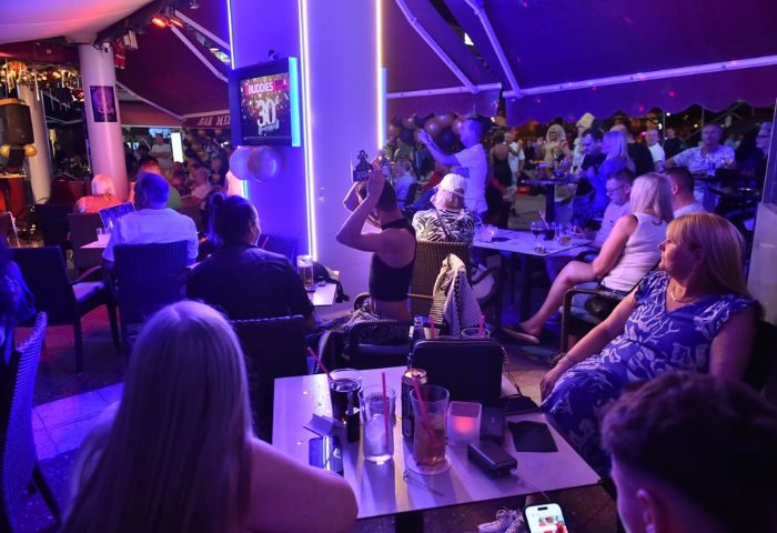 Buddies Bar, a gay bar in Gran Canaria, is packed with people. It's a lively scene with drinks and good times. Gay travel advice.