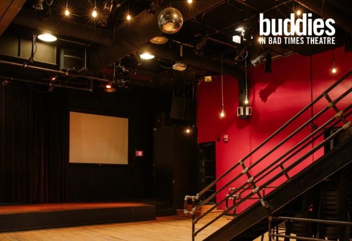 Buddies in Bad Times Theatre, Toronto. Interior view of the gay-friendly venue, stage, disco ball, and red wall. Gay travel advice.