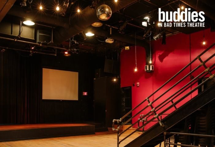 Buddies in Bad Times Theatre, Toronto. Interior view of the gay-friendly venue, stage, disco ball, and red wall. Gay travel advice.