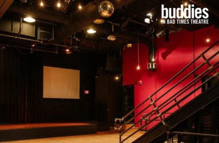 Buddies in Bad Times Theatre, Toronto. Interior view of the gay-friendly venue, stage, disco ball, and red wall. Gay travel advice.