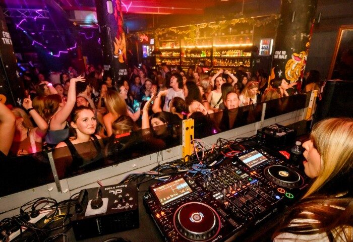 Burdekin Hotel Sydney: DJ spins for a packed, energetic crowd. Popular gay bar known for its vibrant nightlife and inclusive atmosphere.