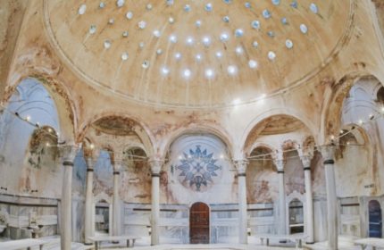 Cagaloglu Hamam interior, Istanbul. Dome with light holes, columns, arches, and marble benches. Gay travel advice, Turkish bath.