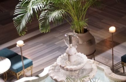 Cagaloglu Hamam Istanbul interior. Fountain, plants, candles, and seating create a relaxing spa atmosphere. Gay travel advice.