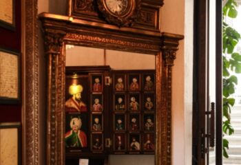Ornate mirror reflecting portraits at Cagaloglu Hamam, Istanbul. A unique cultural experience for gay travelers seeking authentic Turkish baths.