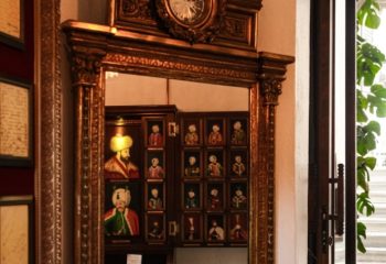 Ornate mirror reflecting portraits at Cagaloglu Hamam, Istanbul. A unique cultural experience for gay travelers seeking authentic Turkish baths.