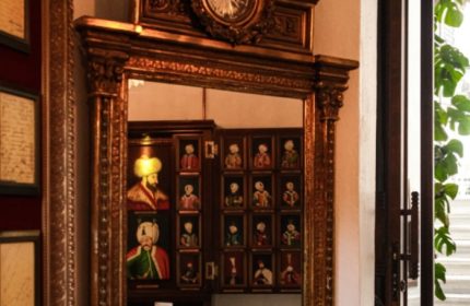 Ornate mirror reflecting portraits at Cagaloglu Hamam, Istanbul. A unique cultural experience for gay travelers seeking authentic Turkish baths.
