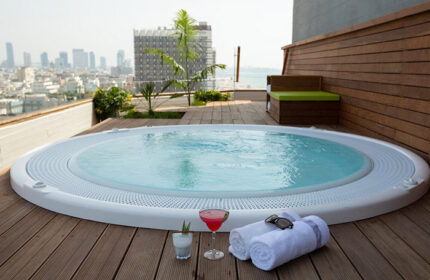 Carlton Tel Aviv Hotel luxury honeymoon suite. Rooftop jacuzzi, cocktails, towels, & sunglasses. Most popular gay hotel near Hilton Gay Beach.