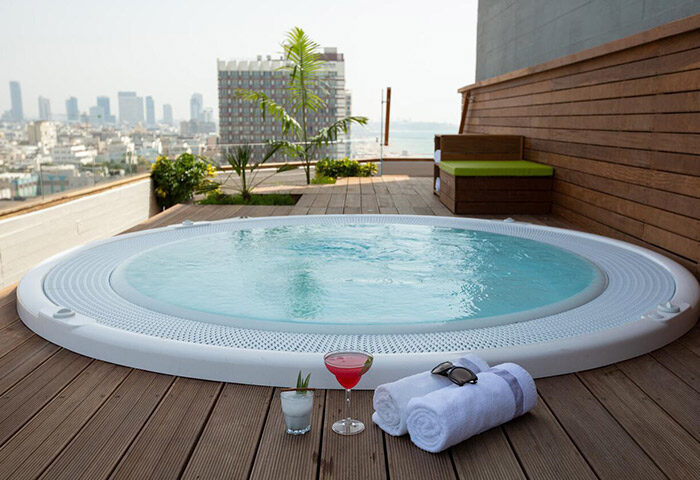 Carlton Tel Aviv Hotel luxury honeymoon suite. Rooftop jacuzzi, cocktails, towels, & sunglasses. Most popular gay hotel near Hilton Gay Beach.
