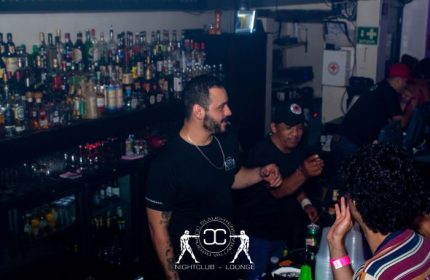 Inside CC Slaughters Nightclub, a popular gay bar in Puerto Vallarta. People are enjoying drinks at the bar. Nightlife scene.