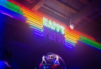 Slaughter's Night Club, gay bar in Puerto Vallarta. Neon sign reads Happy Pride with rainbow colors. LGBTQ+ nightlife travel destination.