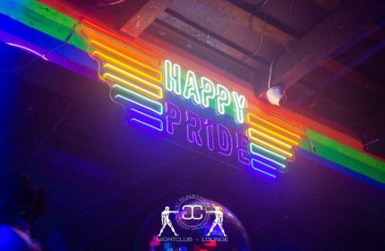 Slaughter's Night Club, gay bar in Puerto Vallarta. Neon sign reads Happy Pride with rainbow colors. LGBTQ+ nightlife travel destination.