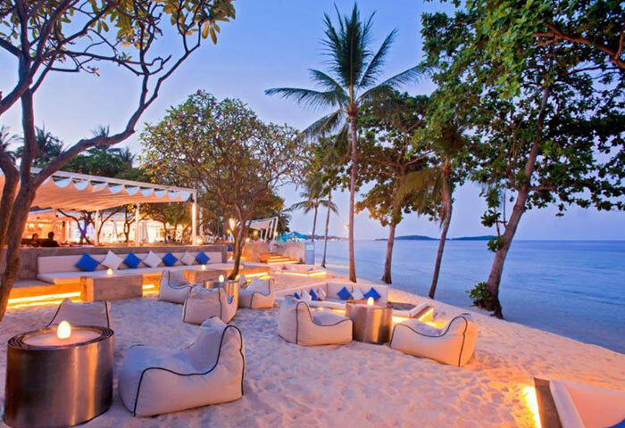 Centara Grand Beach Resort Samui beachfront lounge at dusk. Gay-friendly hotel with beanbag chairs and ocean views. Koh Samui gay travel.