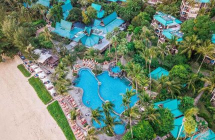 Aerial view of Centara Grand Beach Resort & Villas Krabi, a gay-friendly resort. Pool, beach, lush greenery, & Thai architecture visible.